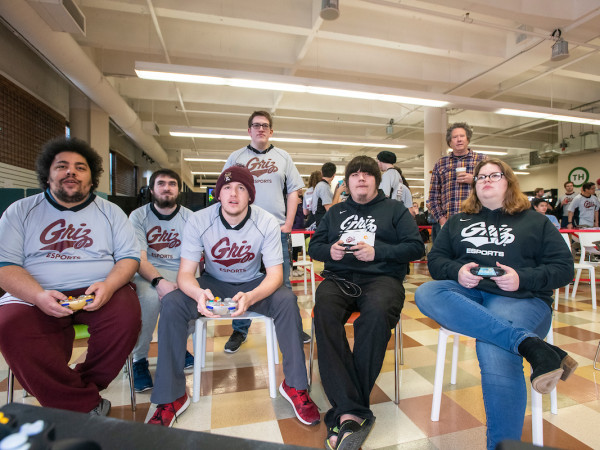 UM students playing video games with Griz shirts on.