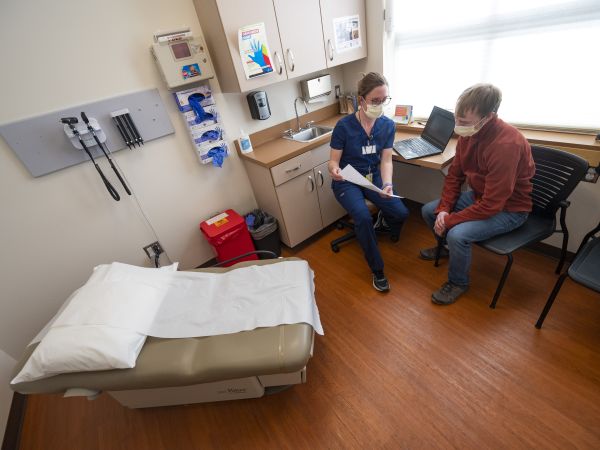 Two people talk in a medical office 
