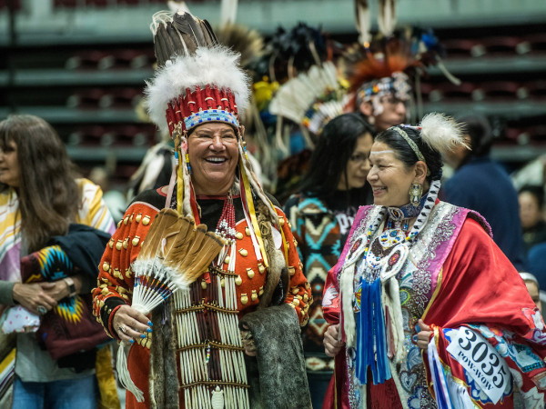 Two women talking at a powwow 