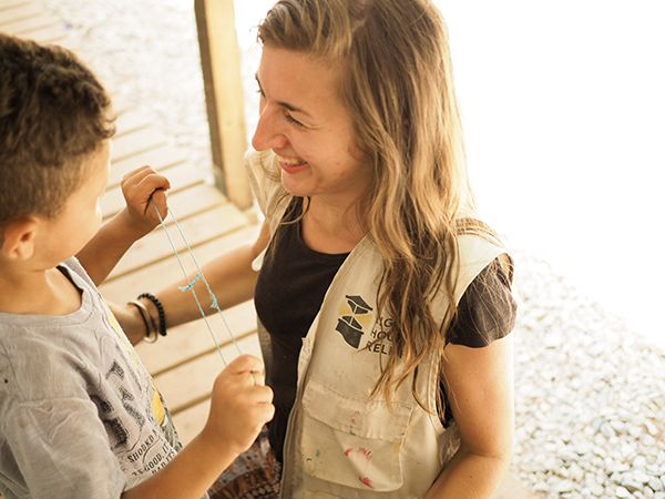 graduate student smiling at a child she is working with