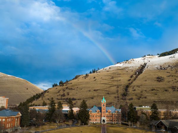 rainbow over main hall with a blue sky