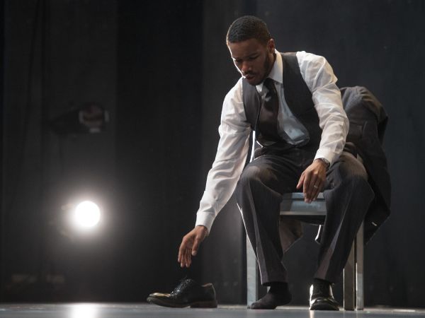 An actor reaching for a show onstage