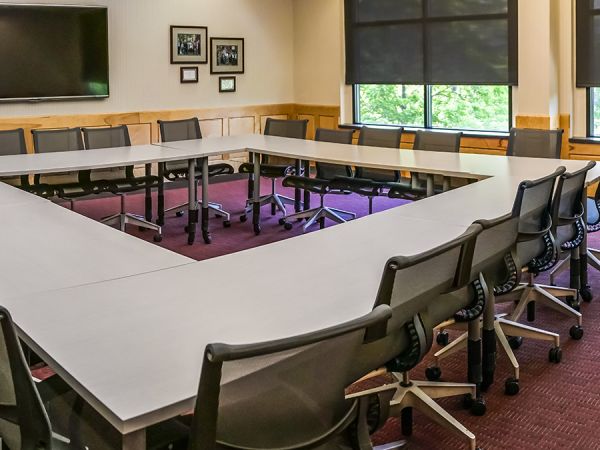 Board room with a large table and multiple chairs 