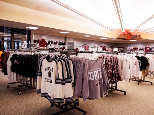 Store with sweaters hanging on racks