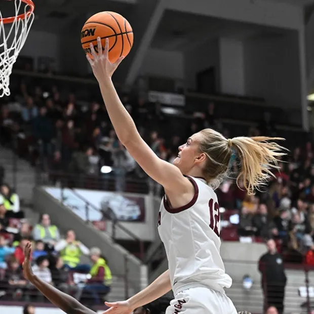 A Lady Griz player goes to the net during a game in Dahlberg Arena