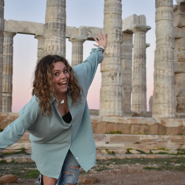 Girl standing in front of monument in Greece