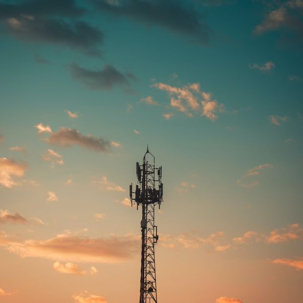 An image of a satellite tower with a cloudy sky background