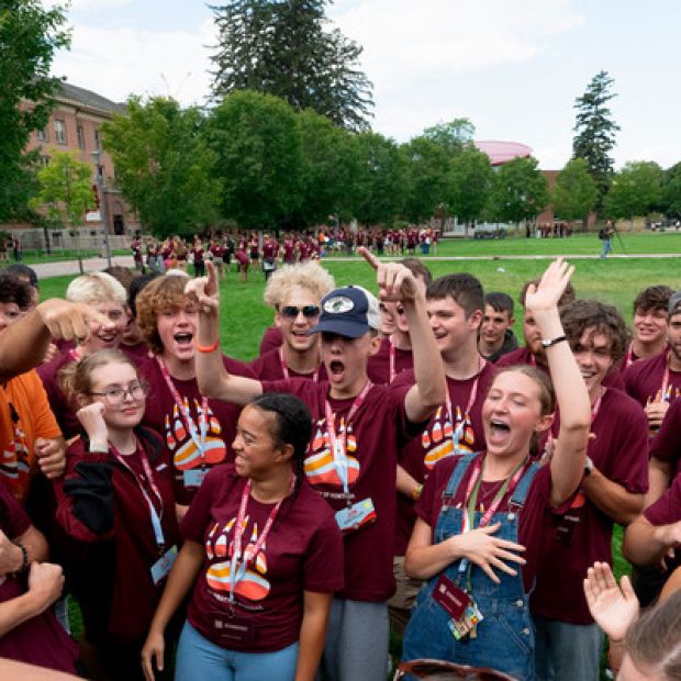 New students jump in a circle on the Oval during a small group game