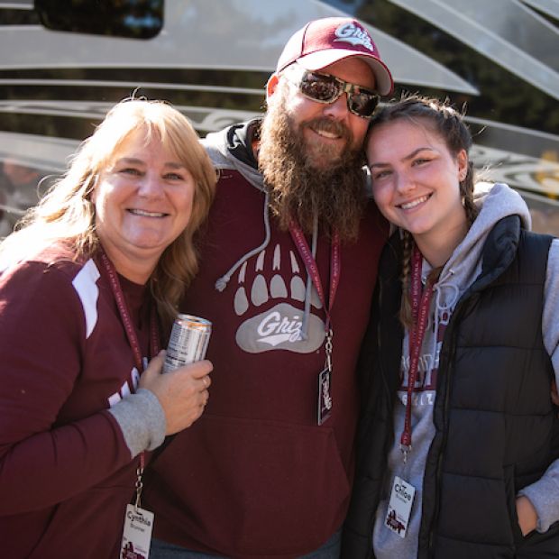 A student and their parents wearing Griz gear at Family Weekend.