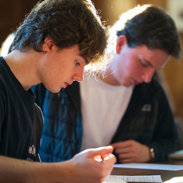 A student and their parent looking at paperwork on the first day of school.