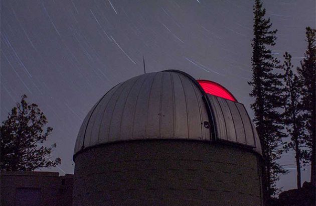 blue montian observatory with stary sky in background