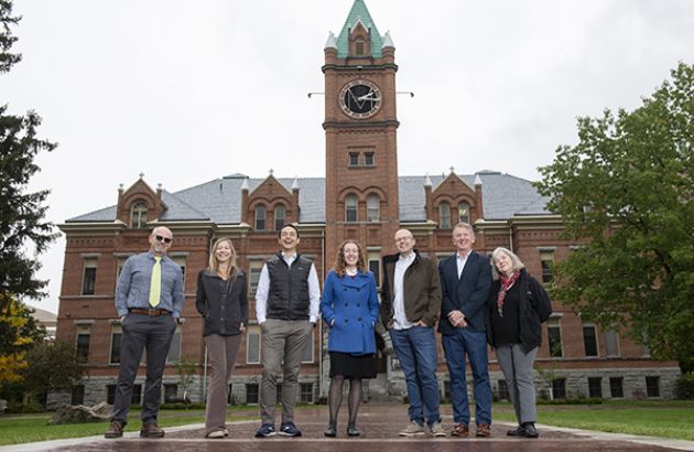 faculty members Tobin Miller Shearer, Kelly Dixon, Scott Arcenas, Gillian Glaes, Kyle Volk, Ashby Kinch and Kathryn Shanley standing in front of main hall