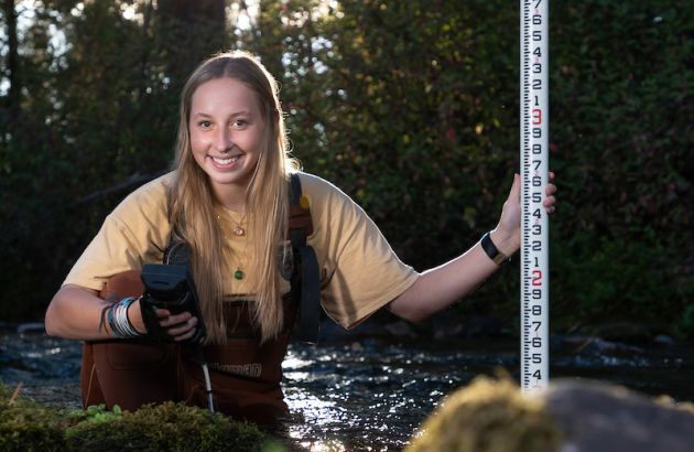A geoscience student surveys Rattlesnake Creek