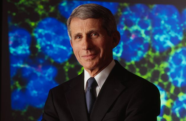 Dr. Anthony Fauci stands facing the camera with his arms crosssed
