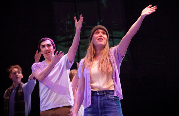 The 2020 Cast of "Spring Awakening" raising their arms in song. 