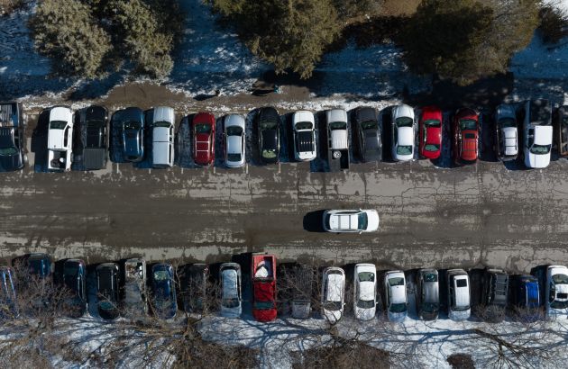 aerial photo of parking lot in winter, only showing to aisles of parking