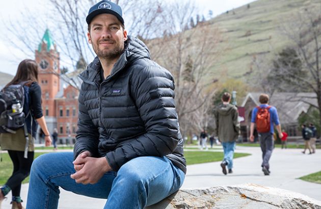 UM student veteran Kyle Brekke sits on the Oval