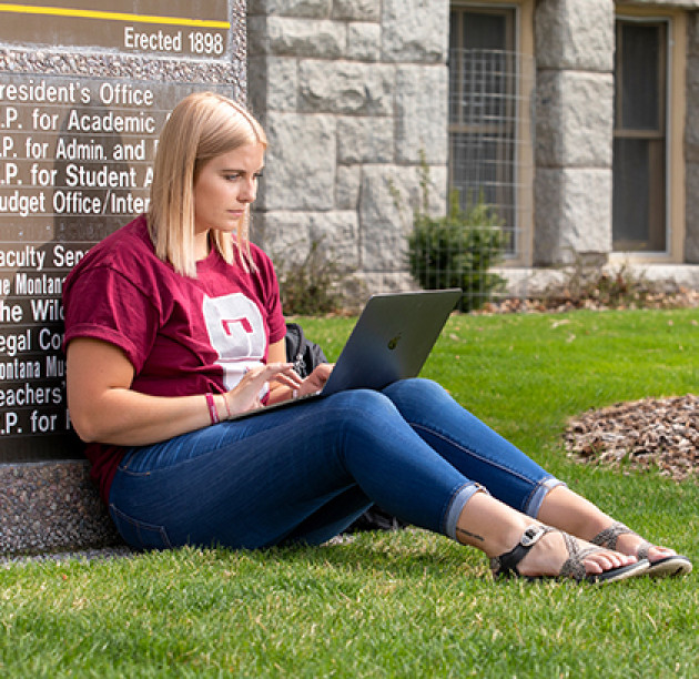 student studying on laptop