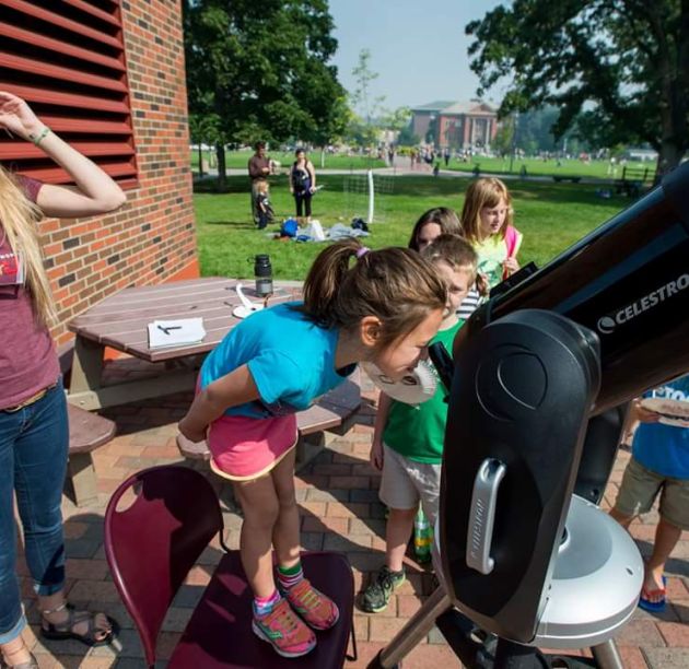 Children at Science Stargazing Camp looking in telescopes