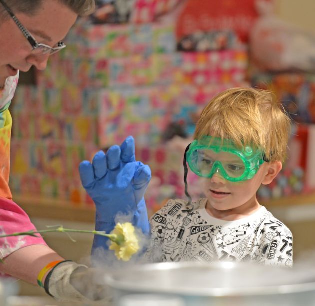 Child and educator at a spectrUM Birthday party doing Liquid Nitrogen experiments and demonstrations