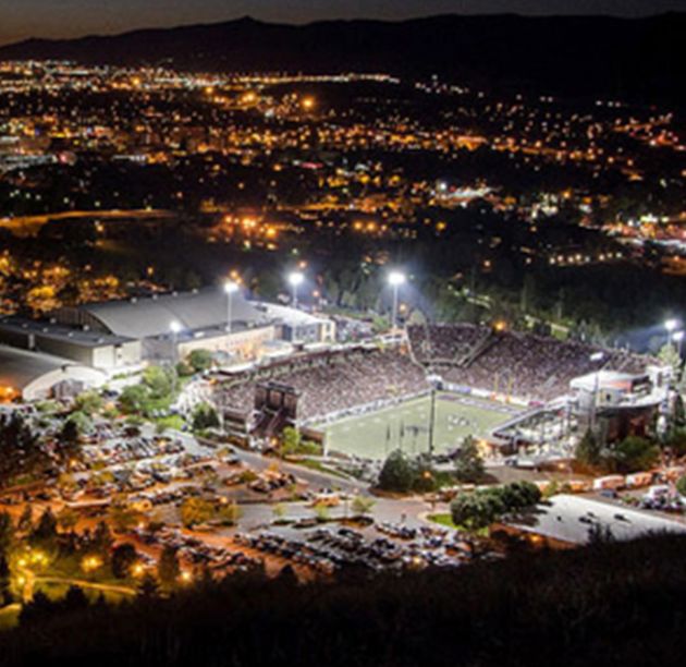 Looking down at Washington-Grizzly Stadium during a night football game.