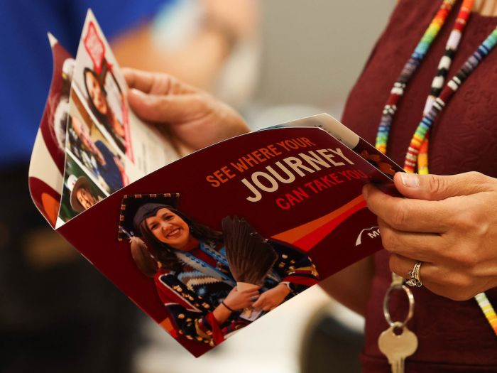 Woman holding UM Brochure