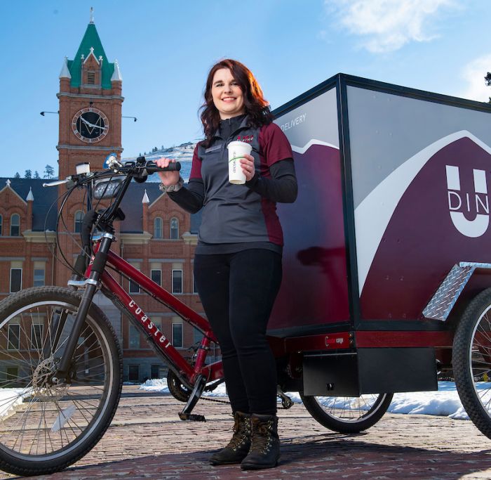 Katie Helms in front of the pedal powered UM Dining cart