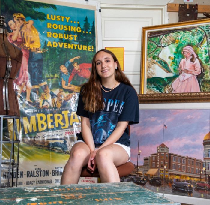 Beth Schofield sits amongst historical pieces at the Historical Museum at Fort Missoula