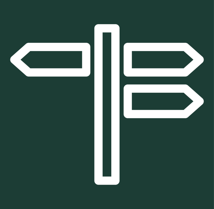 white stylized directional sign post icon against a green background