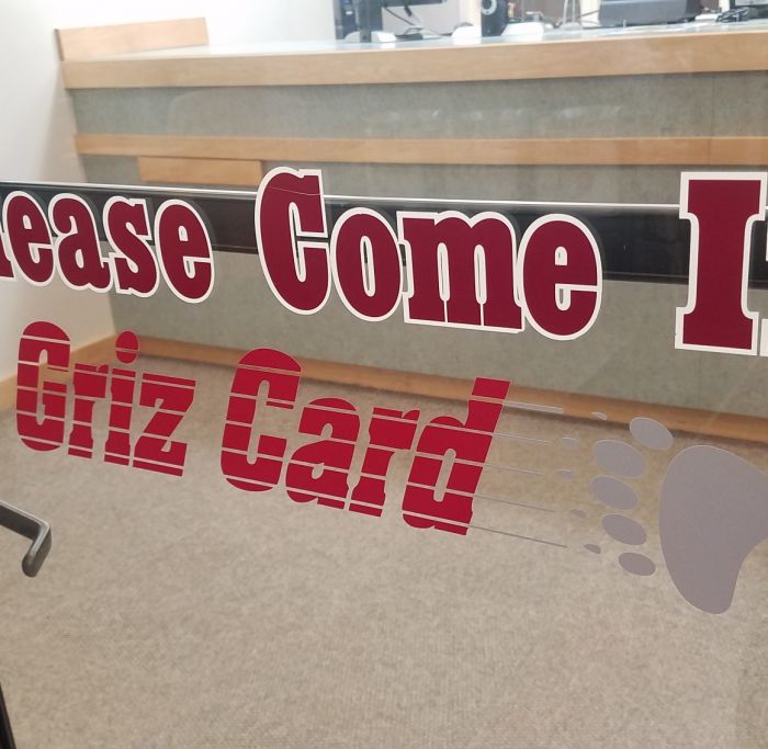 Front door of Griz Card Center saying "Please Come In"