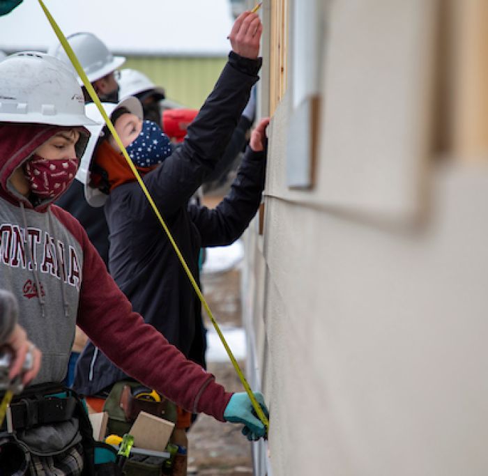 Workforce ready. Student holding a tape measure.