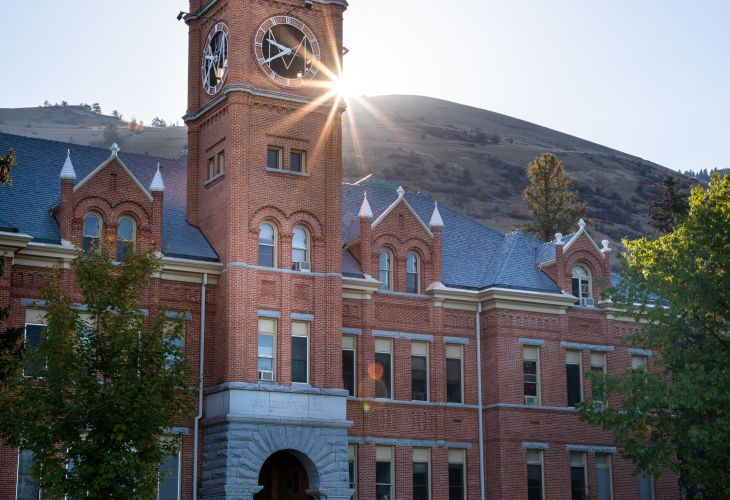 UM's clocktower with the sun rising behind it. 