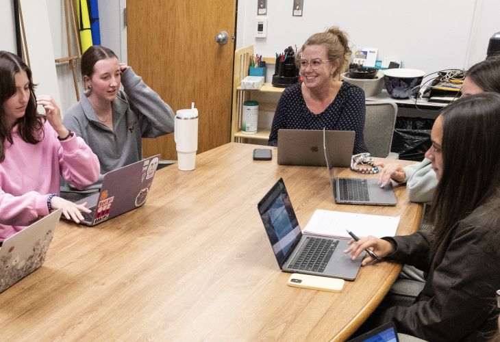 Anisa Goforth looking at a CRESP lab members and smiling during a lab meeting