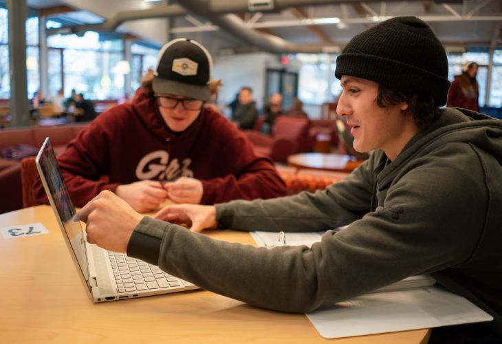 Two UM students with their laptops