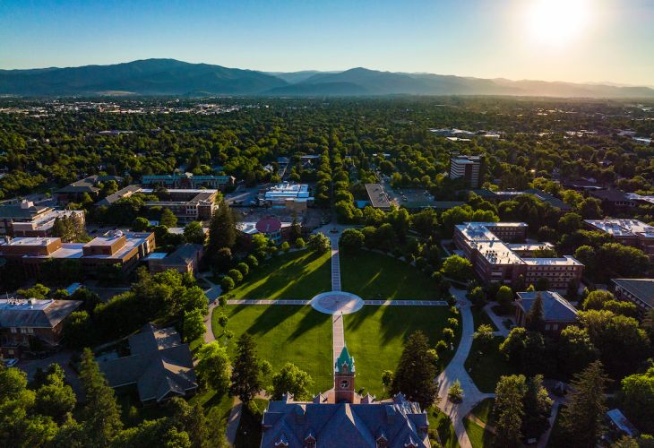 Drone photo of UM Campus in spring,  featuring main hall and the oval