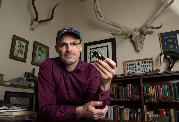 Professor holding a beetle