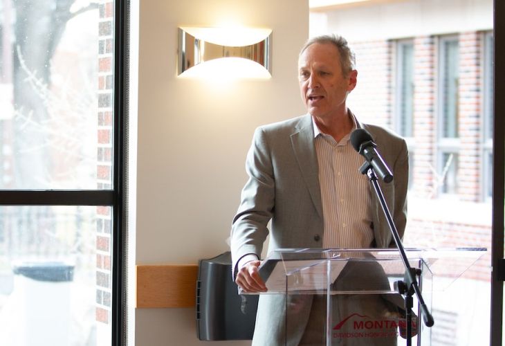 Dean Tim Nichols speaks at podium 