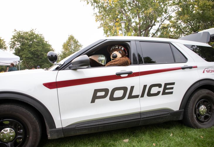 Monte in a campus police car