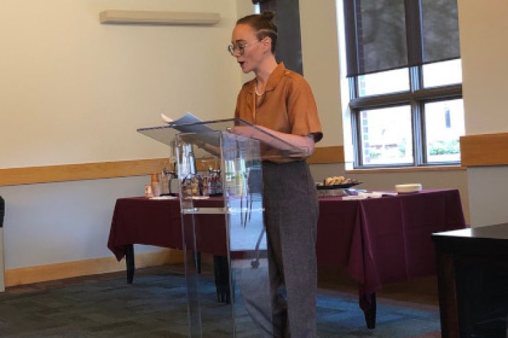 Graduating Senior, Abigail H., reads a piece during the capstone project readings in the Davidson Honors College