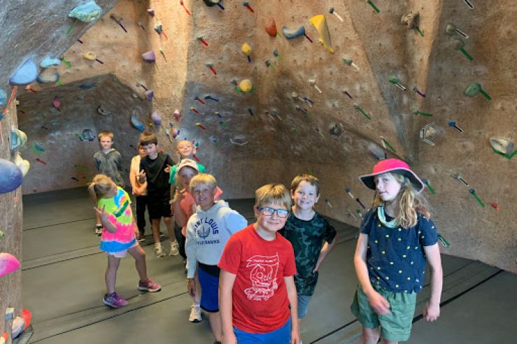 Children on a tour of a climbing gym