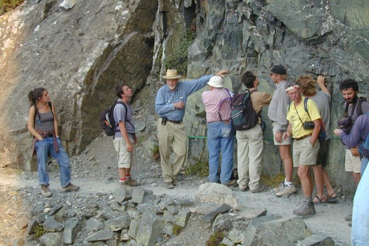 Don and a group in front of a rock face