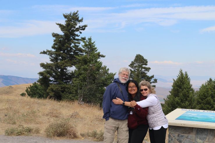 a student hiking with their host family