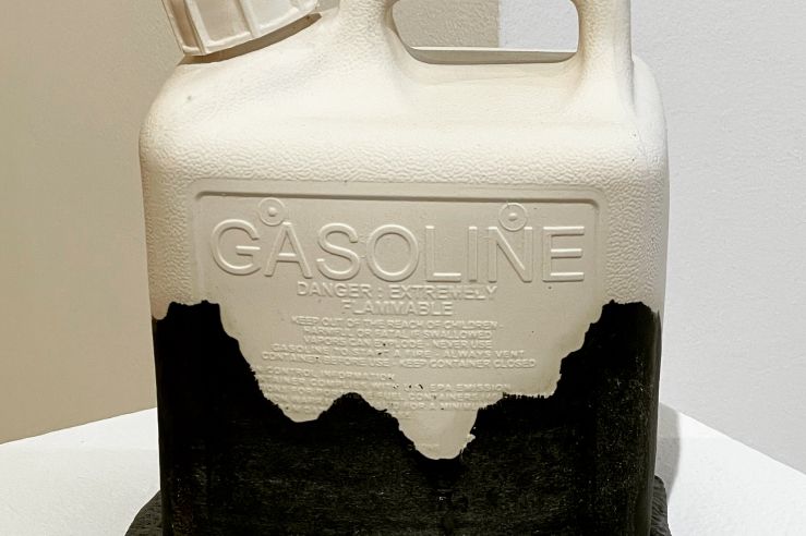 porcelain cast gasoline container, white with a black glaze "stain" covering the bottom half as if something has been spilled on it