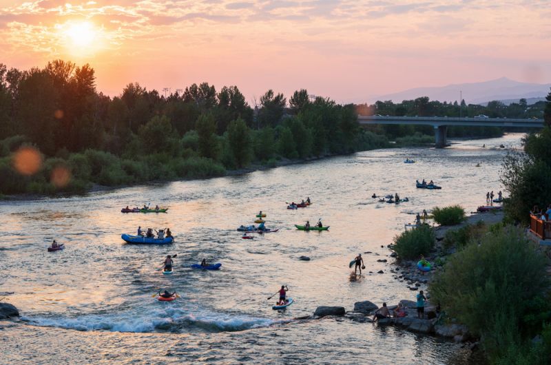 People floating the Clark Fork River at sunset