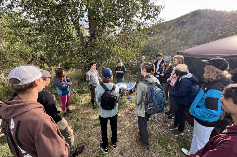 UMBEL staff speaks with members of the Bitterroot Bird Alliance at MPG Ranch in 2024.