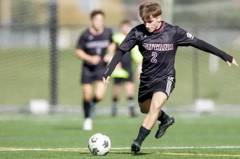 Griz Men's Soccer player kicking ball