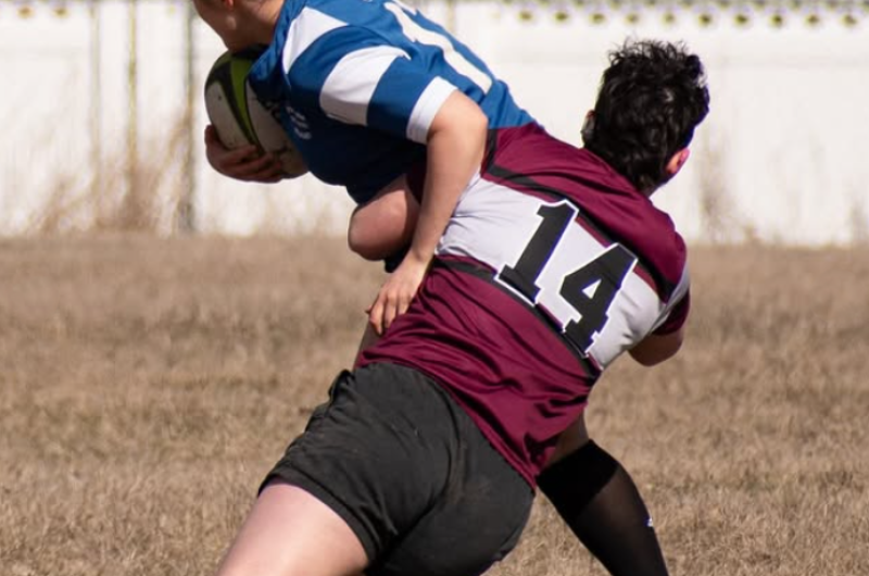 Griz Women's Rugby Player Making a Tackle