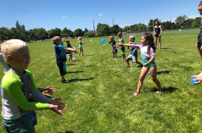 Children playing and throwing water ballons back and forth
