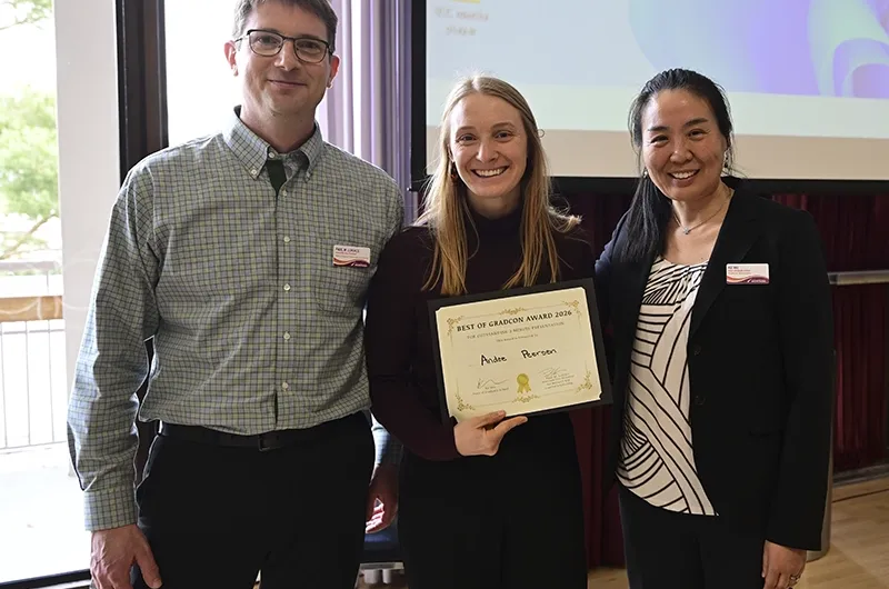 Ande Peersen posing with two people