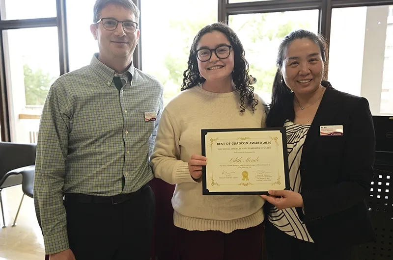 Edith Meade posing with two people